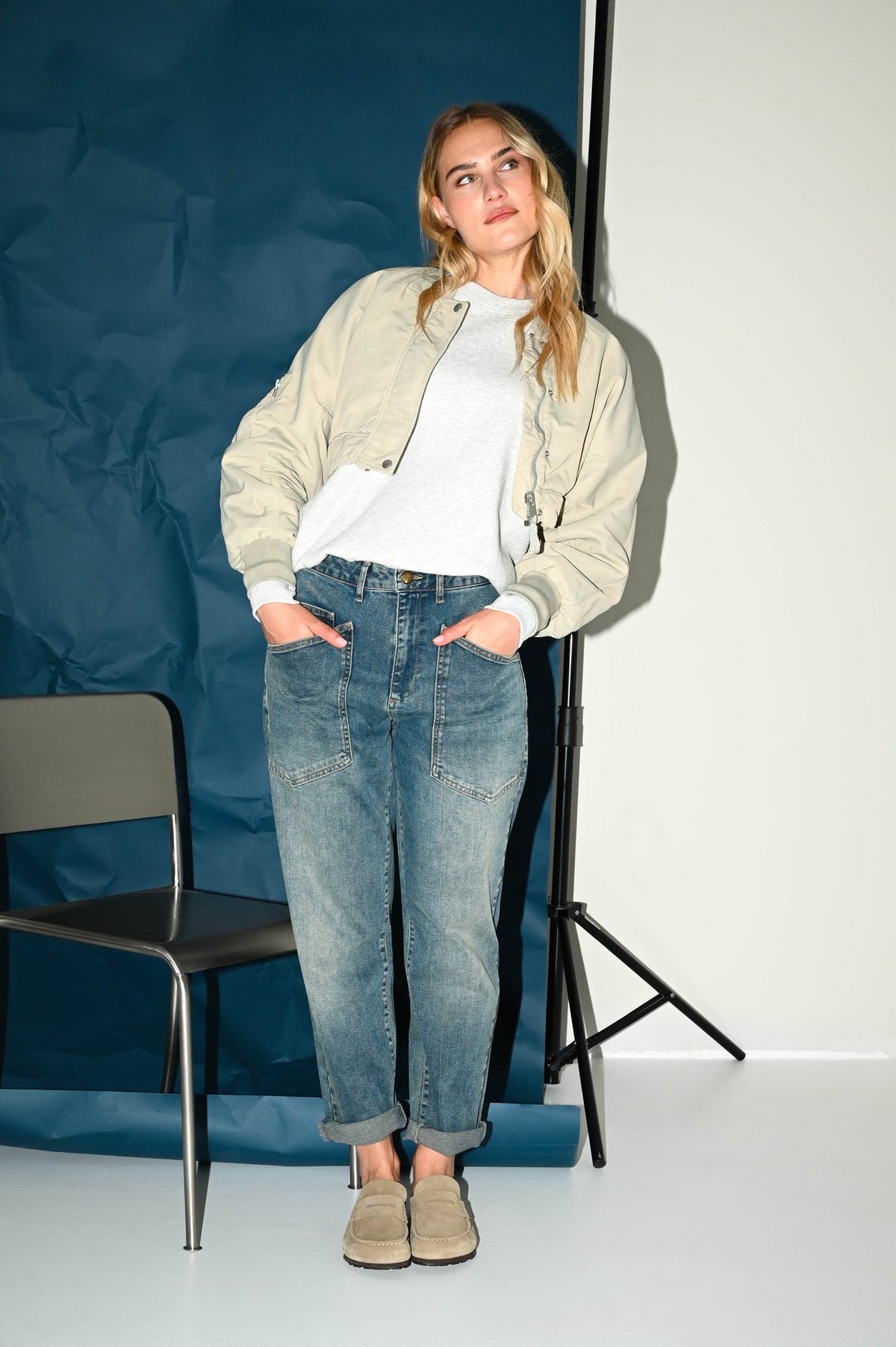 de carrot fit jeans in een grijsblauwe denim gecombineerd met een off white jasje en wit shirt zorgt voor een frisse herfstlook
